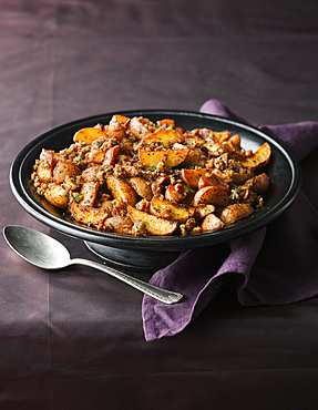 Plate of roasted potatoes and spoon