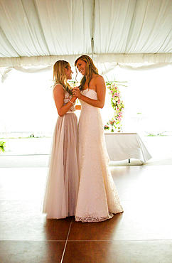 Caucasian brides dancing at wedding