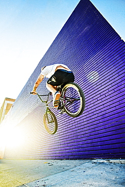 Caucasian man jumping on BMX bike