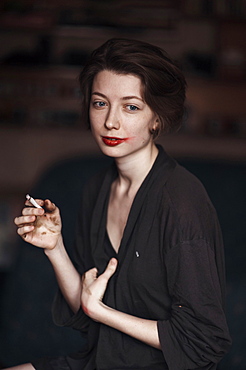 Caucasian woman smoking indoors