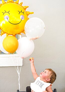 Baby girl (12-17 months) with balloons