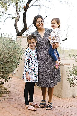 Portrait of mother with two daughters (2-3, 8-9)