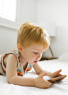 Boy (2-3) using smart phone