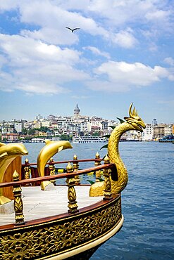 Turkey, Istanbul, Gold serpent and dolphins on bow of ship on Bosphorus