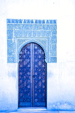 Spain, Granada, Blue ornate door and carvings of the Alhambra