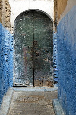 Fes Morocco Colorful blue walls and old door in one of the many alleyways in the medina