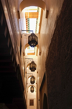 Fes Morocco Metal streetlamps line the upper walls in one of the medina alleys
