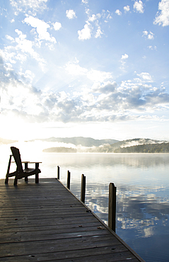 Boat dock at sunrise, Lake Placid, New York, USA