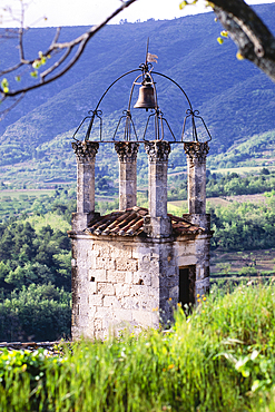 Old church bell tower in hilly landscape