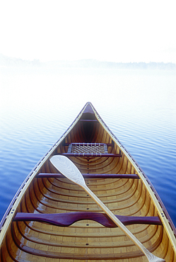 Wood canoe in morning mist on Saranac Lake