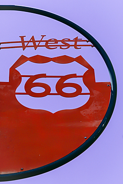 Red sign along Route 66 against sky