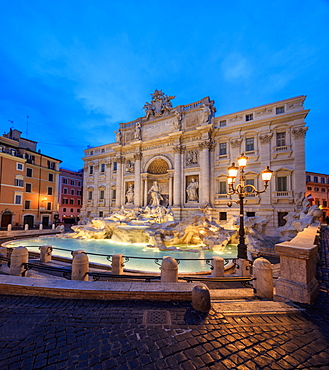 Panorama of Trevi Fountain illuminated by street lamps and the lights at dusk, Rome, Lazio, Italy, Europe