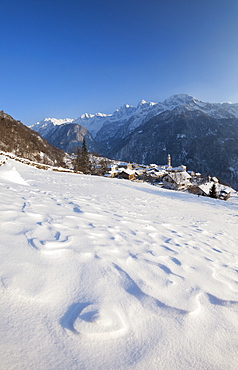 Sunset on the snowy village of Soglio, Maloja District, Bregaglia Valley, Engadine, Canton of Graubunden, Switzerland, Europe