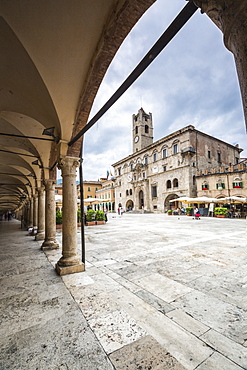 The old arcades frame the historical buildings of Piazza del Popolo, Ascoli Piceno, Marche, Italy, Europe