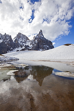 Thawing snow leaving some puddles at the foot of the Pale di San Martino by San Martino di Castrozza, Dolomites, Trentino, Italy, Europe