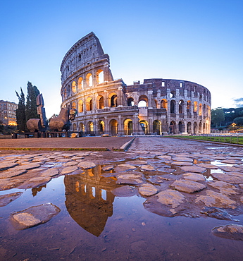 The Colosseum (Flavian Amphitheatre), UNESCO World Heritage Site, reflected in a puddle at dusk, Rome, Lazio, Italy, Europe