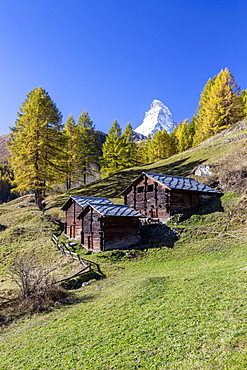 The unique shape of the Matterhorn seen from a little group of mountain huts by Zermatt, Swiss Canton of Valais, Swiss Alps, Switzerland, Europe