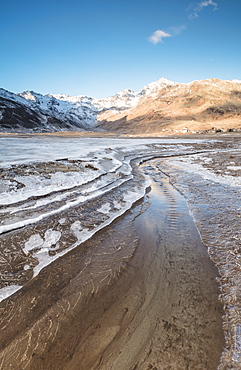 Frozen lake Montespluga at dawn, Chiavenna Valley, Sondrio province, Valtellina, Lombardy, Italy, Europe