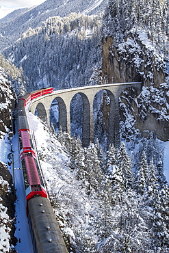 The red train of the Albula-Bernina Express Railway, UNESCO World Heritage on the famous Landwasser Viaduct, Switzerland, Europe