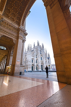 Man looks towards Milan Cathedral (Duomo) from Galleria Vittorio Emanuele II, Milan, Lombardy, Italy, Europe