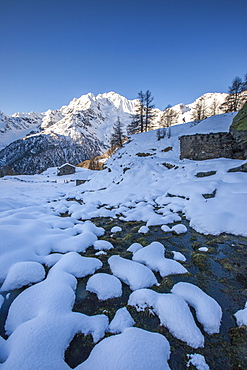 Snow on rocks along the creek with Monte Vazzeda on background, Alpe dell'Oro, Valmalenco, Valtellina, Lombardy, Italy, Europe