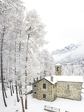 Stone church during winter in San Giuseppe, Valtellina, Italy, Europe