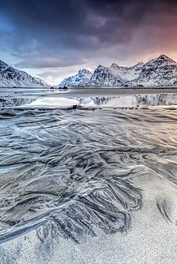 Sunset on the surreal Skagsanden beach surrounded by snow covered mountains, Flakstad, Lofoten Islands, Arctic, Norway, Scandinavia, Europe