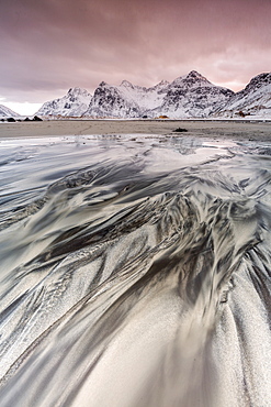 Sunset on the surreal Skagsanden beach surrounded by snow covered mountains, Flakstad, Lofoten Islands, Arctic, Norway, Scandinavia, Europe