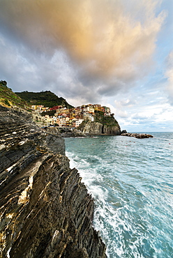 Waves crashing on cliffs at sunset, Manarola, Cinque Terre, UNESCO World Heritage Site, La Spezia province, Liguria, Italy, Europe