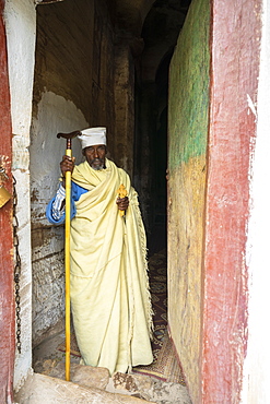 Orthodox priest holding the hand cross at the entrance of Maryam Korkor church, Gheralta Mountains, Tigray Region, Ethiopia, Africa