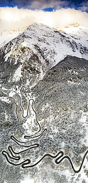 Bends of Maloja Pass road on snowy mountain ridge, aerial view, Bregaglia Valley, Engadine, canton of Graubunden, Switzerland, Europe