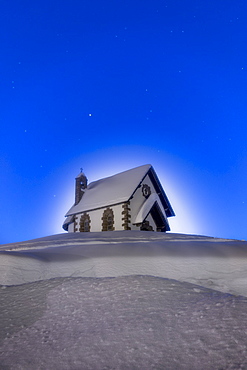 Stars over the church of Madonna Assunta in winter, Rolle Pass, Pale di San Martino, Dolomites, Trentino-Alto Adige, Italy, Europe