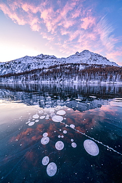 Frozen Lake Sils at sunrise with Piz Da La Margna in background, Engadine, canton of Graubunden, Switzerland, Europe