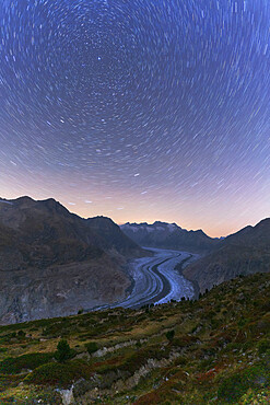 Star trail in the night sky above Aletsch Glacier, Bernese Alps, Valais canton, Switzerland, Europe