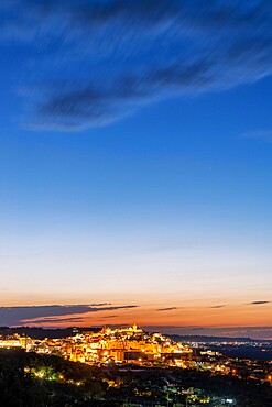 Illuminated old town of Ostuni at dusk, province of Brindisi, Salento, Apulia, Italy, Europe