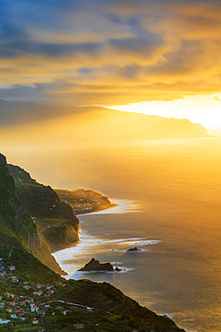 Burning sky at sunset over Arco de Sao Jorge and Ponta Delgada villages ocean front, Madeira island, Portugal, Atlantic, Europe