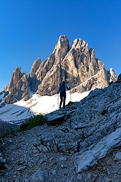 Silhouette of woman on path with Croda Dei Toni mountain in the background, Val Fiscalina, Sesto Dolomites, South Tyrol, Italy, Europe