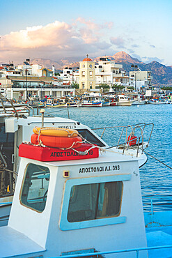 Fishing boats moored in the harbor of the seaside town of Ierapetra at sunset, Crete, Greek Islands, Greece, Europe