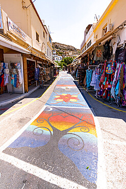 Colorful street paintings among the tourist shops in Matala old town, Crete, Greek Islands, Greece, Europe