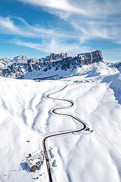 Aerial view of winding mountain road in the snow and Lastoi De Formin, Giau Pass, Dolomites, Belluno province, Veneto, Italy, Europe