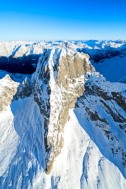 Clear winter sky over majestic Pizzo Badile covered with snow, Val Masino, Valtellina, Sondrio province, Lombardy, Italy, Europe