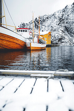 Fishing boats moored in the harbor in the cold Arctic sea, Nusfjord, Nordland county, Lofoten Islands, Norway, Scandinavia, Europe