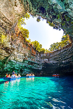 Tourists admiring the cave during a boat trip on the crystal waters of Melissani Lake, Kefalonia, Ionian Islands, Greek Islands, Greece, Europe