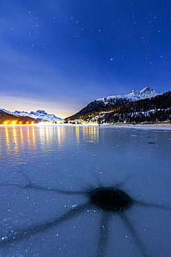 Cracked ice on the frozen surface of Lake Champfer in winter, Silvaplana, Engadine, canton of Graubunden, Switzerland, Europe