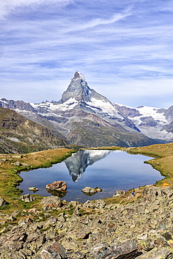 Hikers admire the Matterhorn reflected in Lake Stellisee, Zermatt, Canton of Valais, Pennine Alps, Swiss Alps, Switzerland, Europe