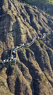 Tourists climbing up a steep mountain, Wuyi Mountains, UNESCO World Heritage Site, Fujian, China, Asia