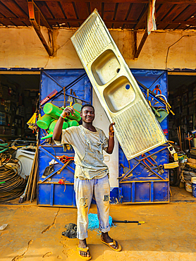 Man holding an entire sink, Wau, Western Bahr el Ghazal, South Sudan,