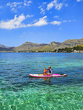 Girln on a SUP in the turquoise waters of the Formentor Peninsula, Mallorca, Balearic islands, Spain, Mediterranean, Europe