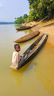 Boy in canoe, Sangha River, Unesco site Dzanga Sangha National Park, Central African Republic