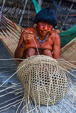 Woman from the Yanomami tribe weaving a basket, southern Venezuela, South America